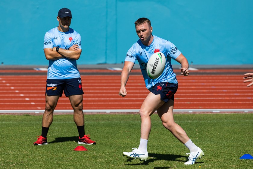 Learning From the Best: Jake Turpin in action during pre-season training, with Club legend Cooper Cronk watching on. 