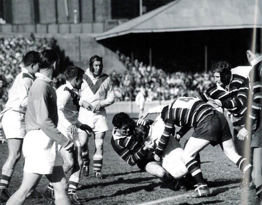 Fierce Rivals: Easts host St George in 1953, with Jack Gibson taking down an opponent in a ferocious tackle. Loyal clubman John Bell (right with headgear) assists. 