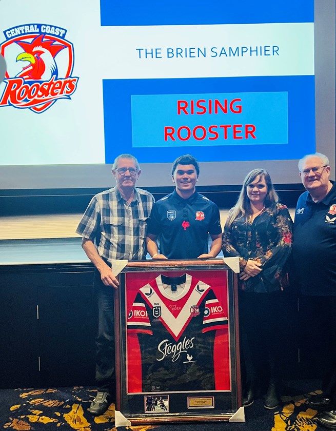 Brien Samphier presents Riley Ilham with the Rising Rooster Award alongside his mother and grandfather.