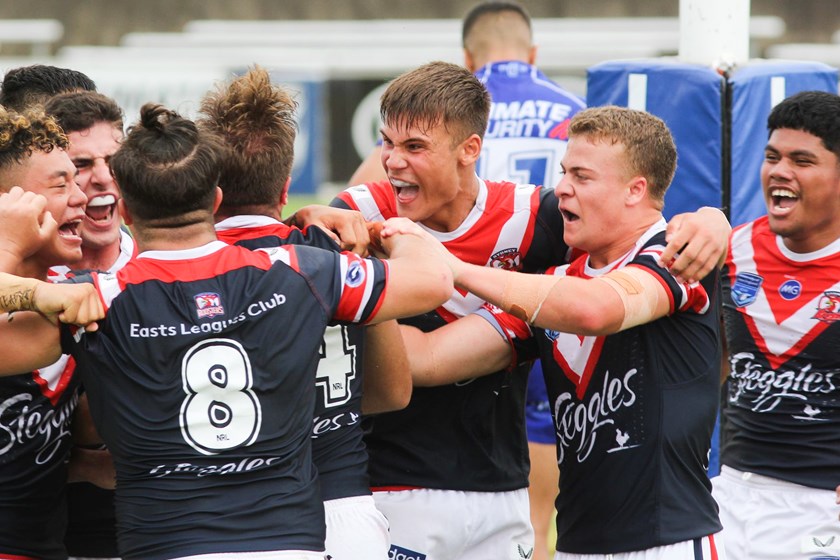  Sydney Roosters players get around Brent Hawkins after he scored the winning try.