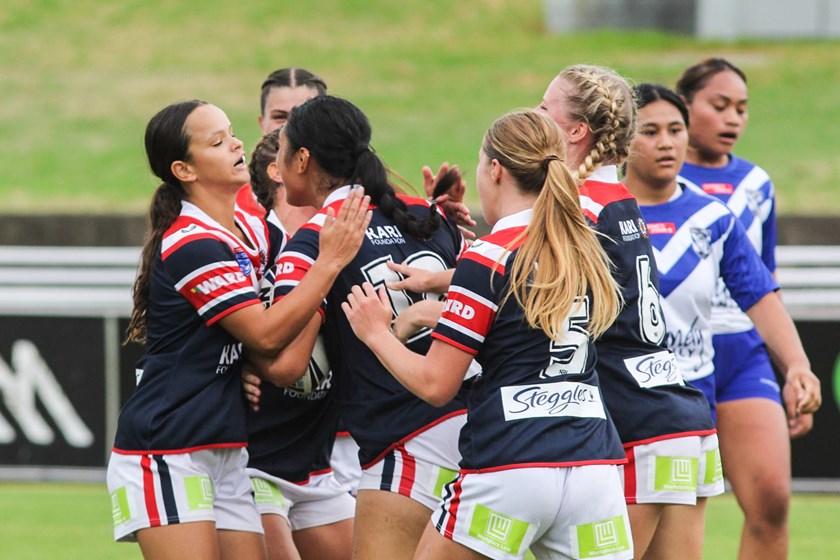  Sydney Roosters players get around Otesa Pule after she scored the first of her two tries.