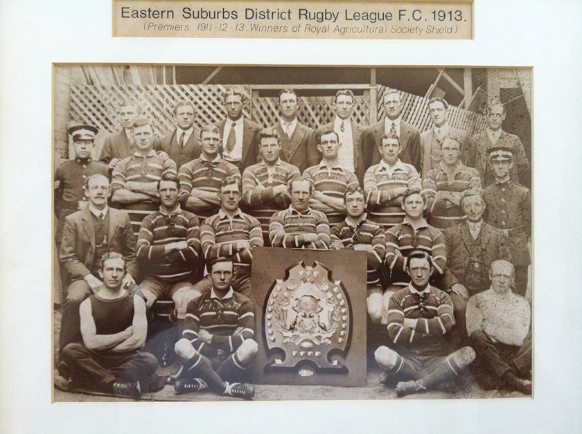 Three Time Champions: The Eastern Suburbs side of 1913 pictured with the Royal Agricultural Society Shield, having claimed their third consecutive premiership. The Club awarded the shield to Dally Messenger (pictured directly behind it) after claiming their third title. 