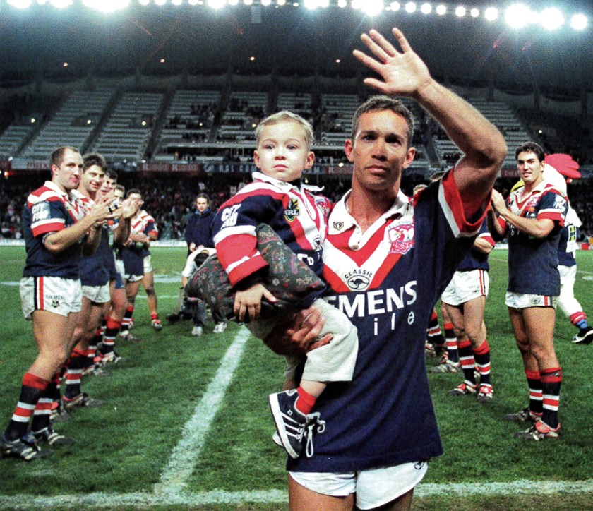 Farewell, Bondi: Adrian Lam salutes the crowd following the final home game at the Sydney Football Stadium in 2000, which would also be his final season at the Club. Son Lachie, pictured, made his NRL debut with the Club nearly two decades on. 