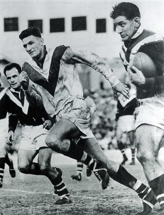 On the Burst: Rupert Mudge is chased down by formidable St George figure Norm 'Sticks' Provan.