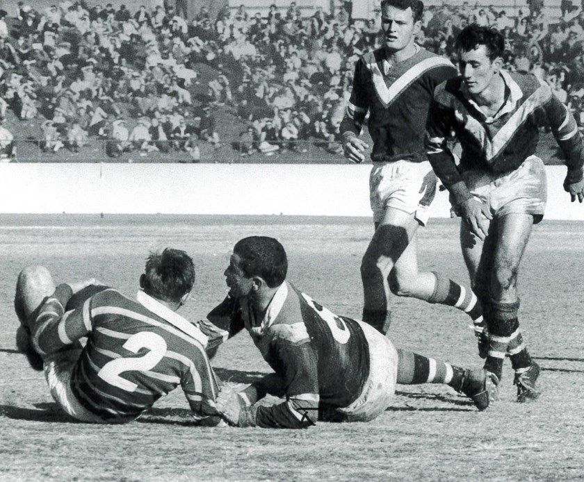 Here's How You Do It: Youngsters Paul Cross and Kevin Junee (background) watch on as English lock Mick Phillips brings down a Parramatta winger at the Sydney Sports Ground in 1965.