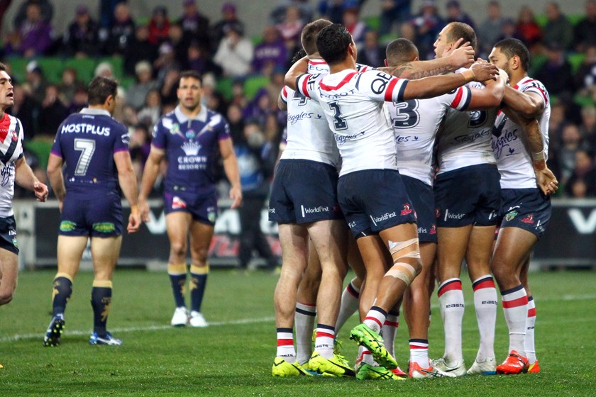 The Roosters rally around Blake Ferguson after he opens the scoring against the Storm on their ground.