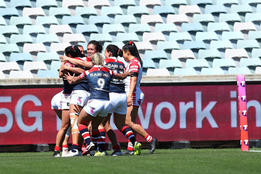 The team swarm Corban McGregor after she seals the win for the Roosters.