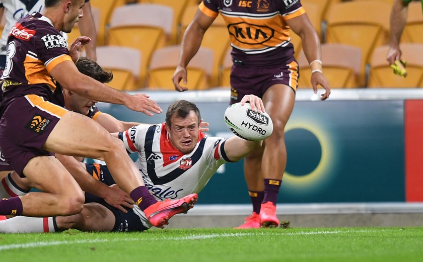 Morris fights his way through the Broncos line to score his first Roosters try